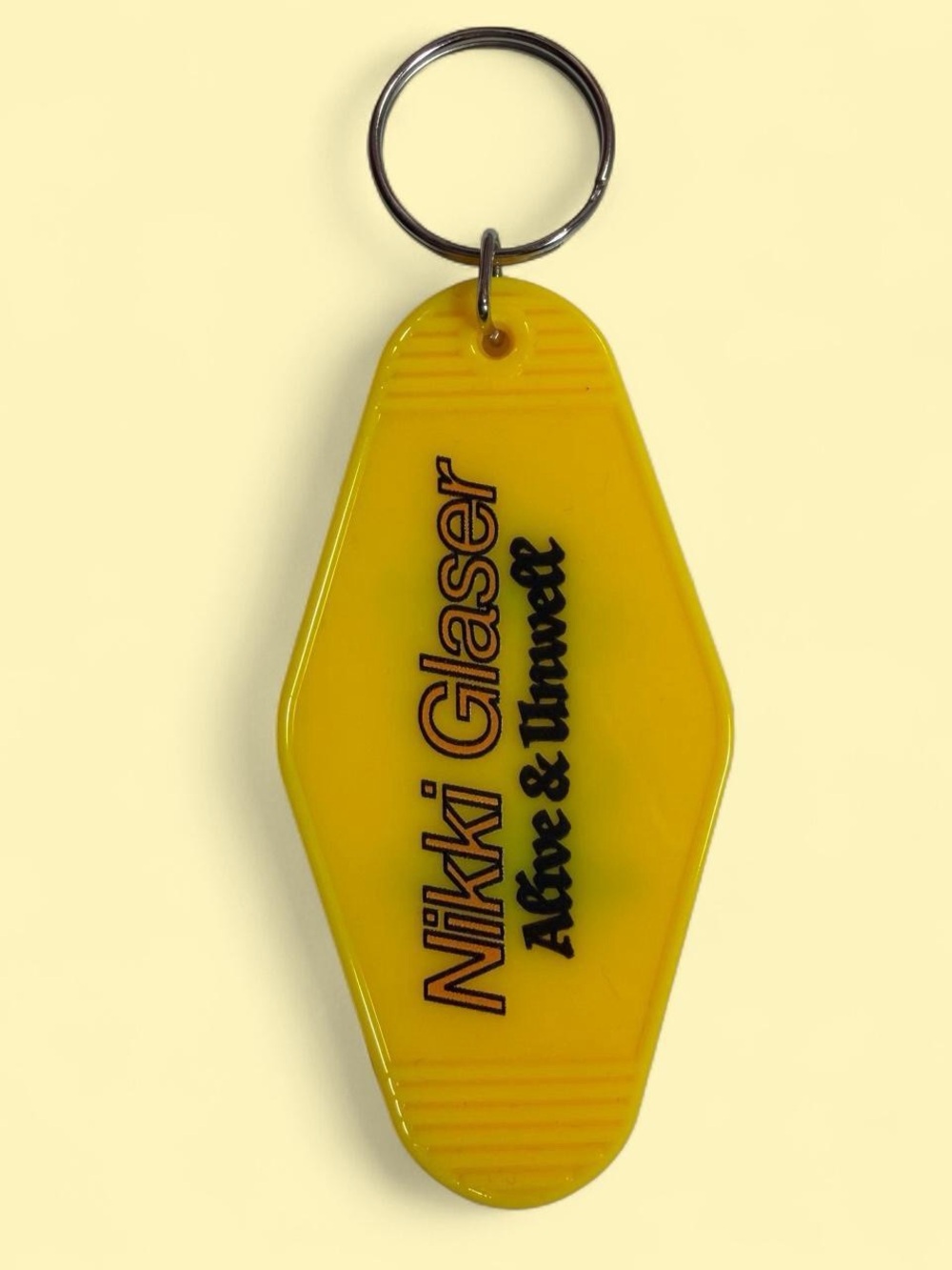 Nikki Glaser Alive and Unwell Tour Yellow Key Motel Style Keychain